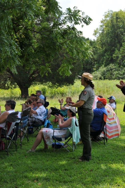 Park employee Ava Joiner listens to the music along with some 100 other visitors.